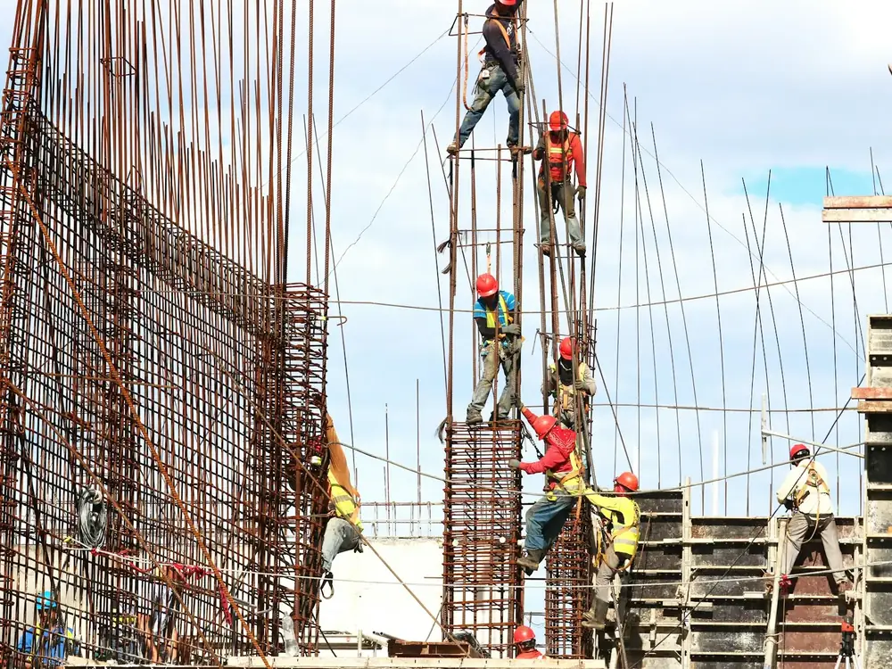Workers tying reinforcement steel on site