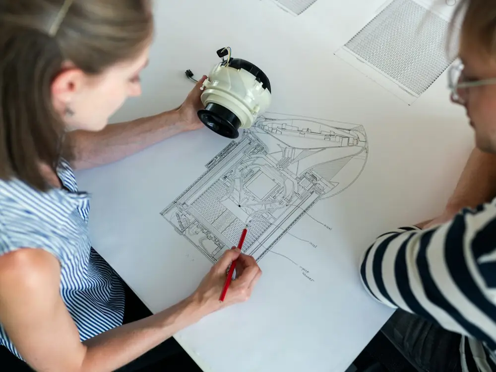 Two engineers reviewing a technical drawing together