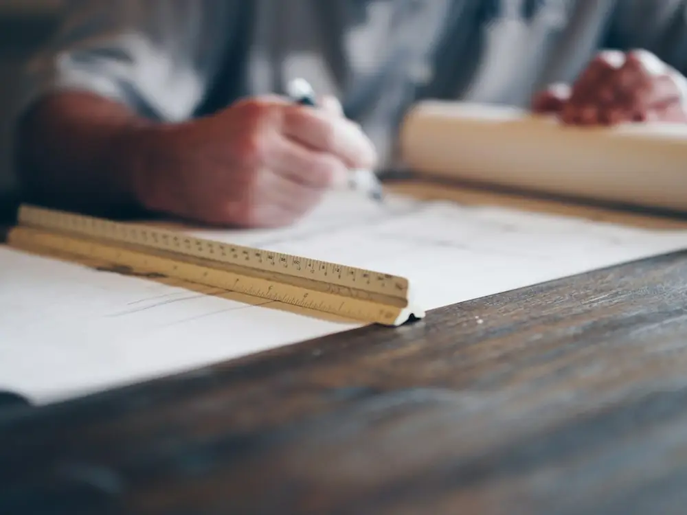 Hand drafting a drawing with a ruler