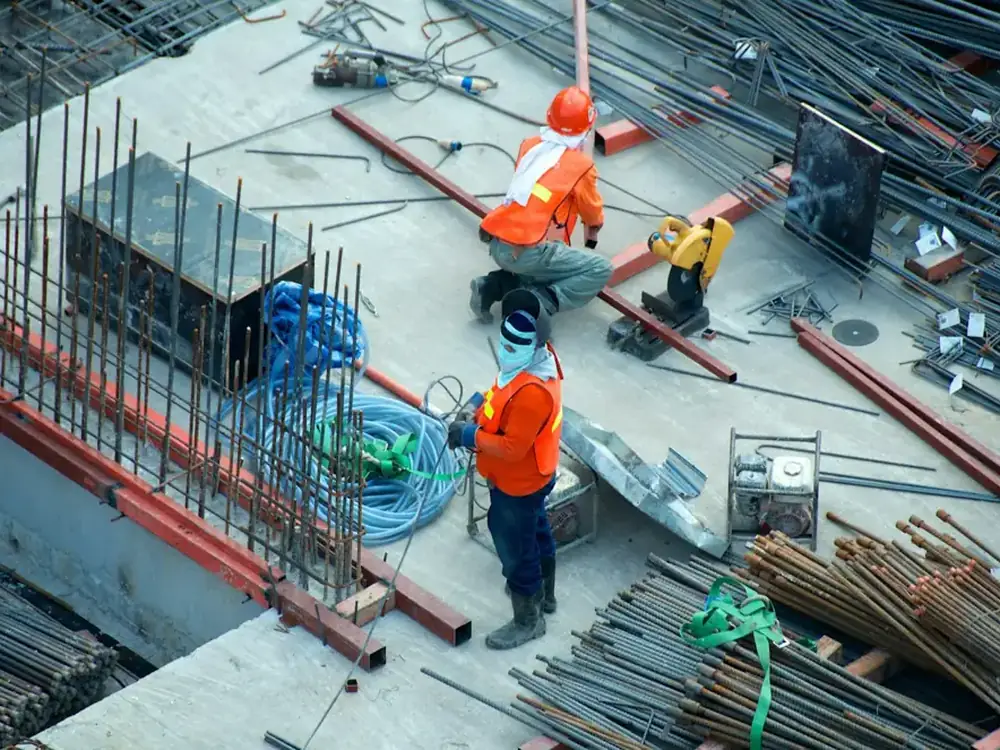 Site crew laying reinforcement on a slab